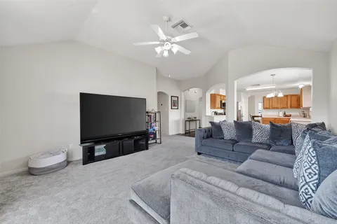 a living room with furniture and a flat screen tv