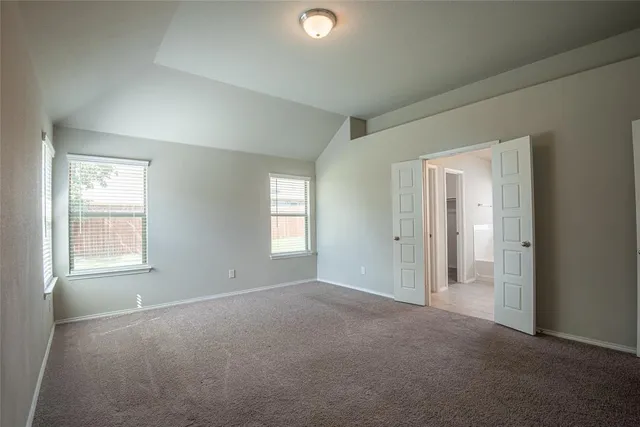 an empty room with windows and closet