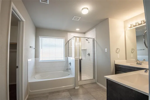 a bathroom with a bathtub shower and a sink