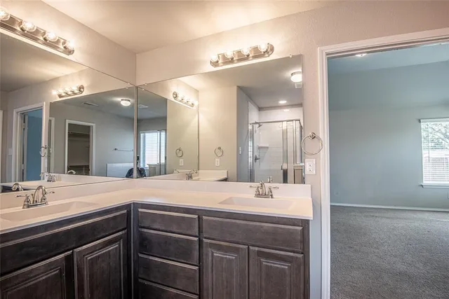 a bathroom with a sink double vanity and a mirror