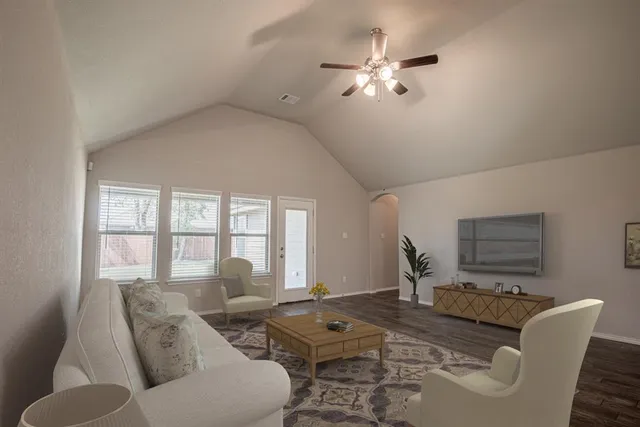 a living room with furniture and a chandelier