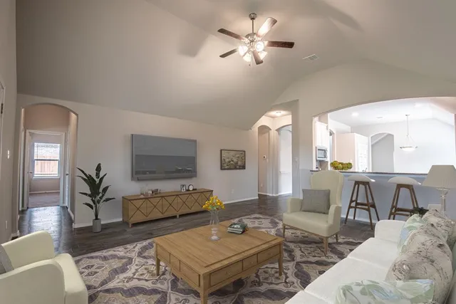 a living room with furniture a rug and a chandelier