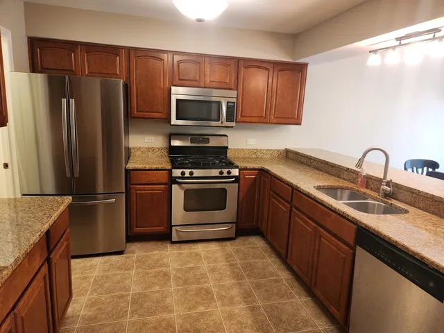 a kitchen with a sink stove and refrigerator