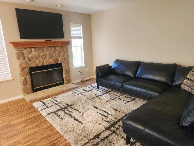 a living room with a couch and a fireplace