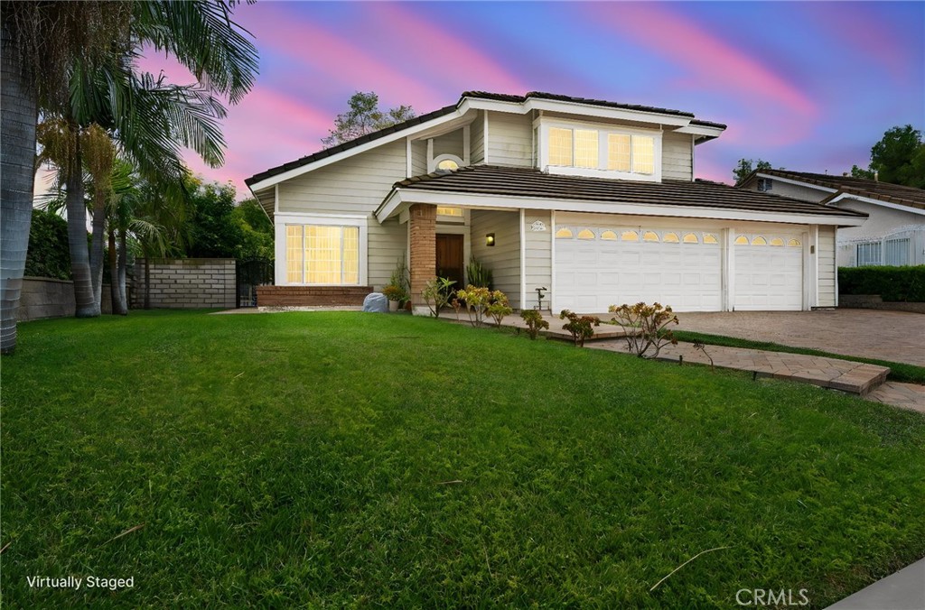 605 Bronco Way Walnut, CA 91789 - Photo 4 of 69 a front view of a house with a garden and yard