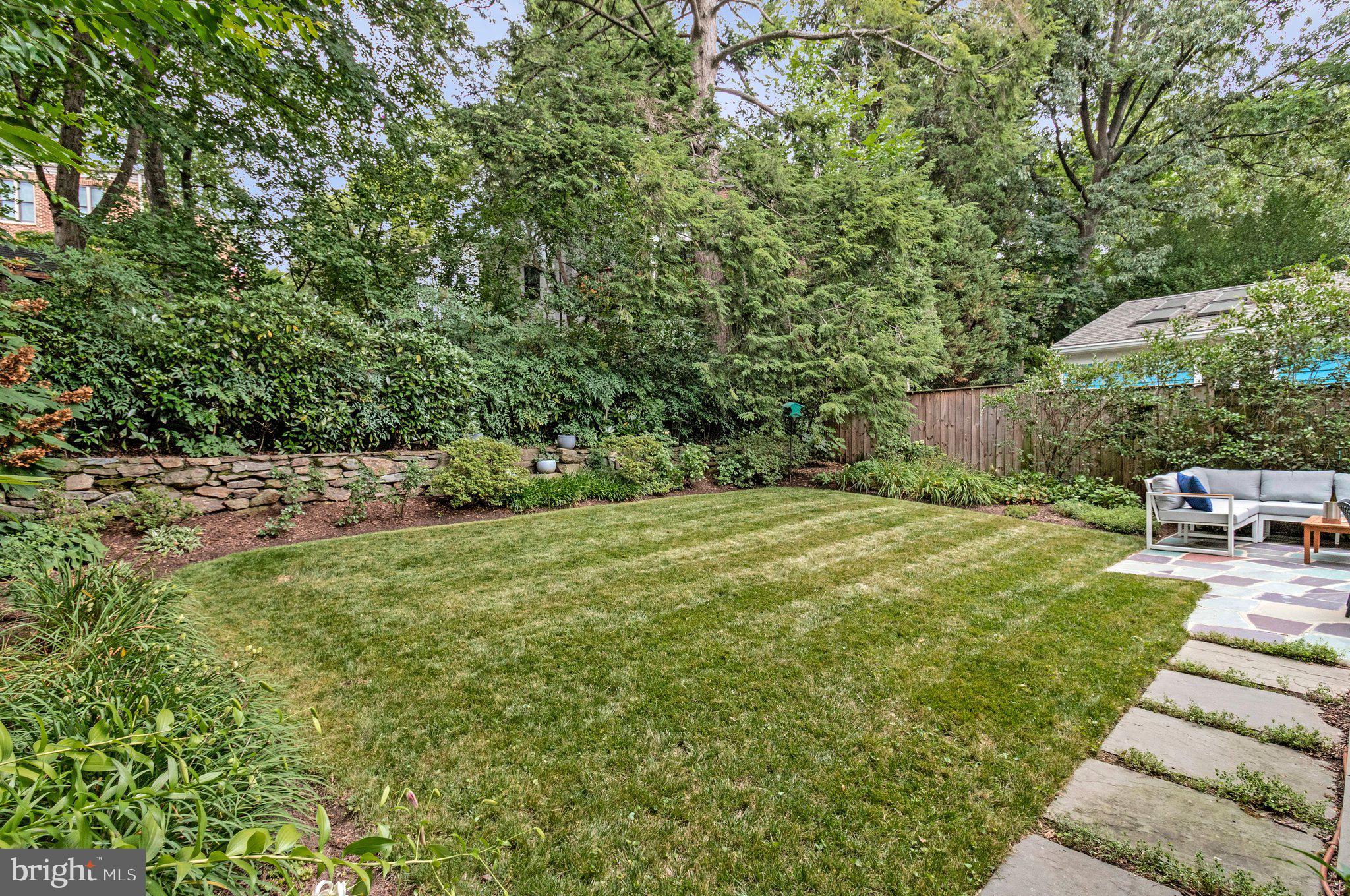 4745 Reservoir Road Northwest Washington, DC 20007 - Photo 25 of 47 Classic stone retaining wall, putting green grass.