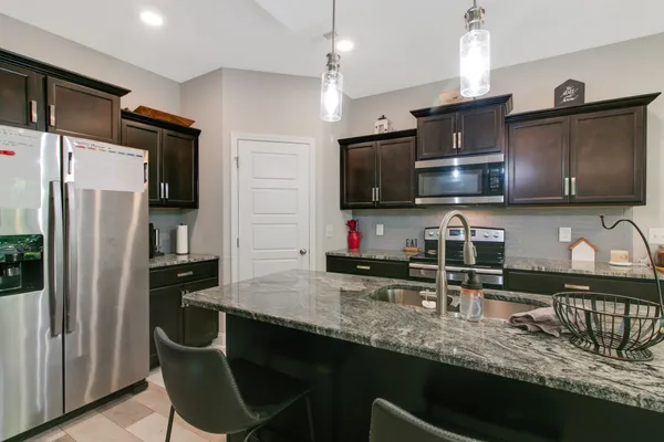 a kitchen with a table and a refrigerator