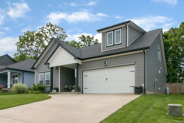 a front view of a house with garden