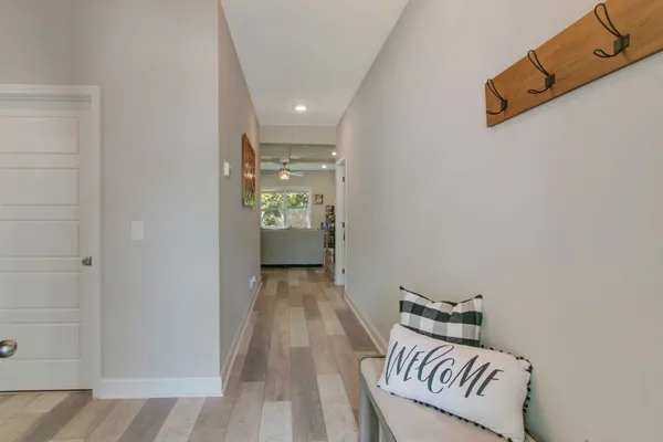 a view of a room with wooden floor and cabinets