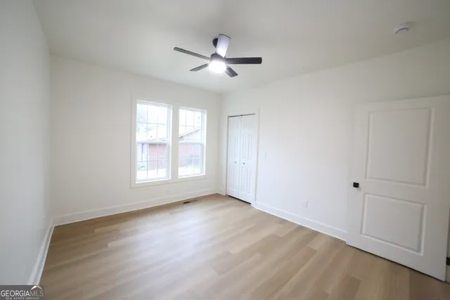 a bathroom with a sink mirror vanity and toilet