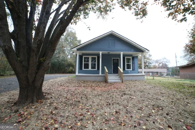 a view of a backyard with large trees