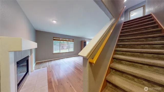 a view of entryway and hall with wooden floor