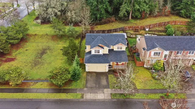 an aerial view of a house with a yard basket ball court and outdoor seating