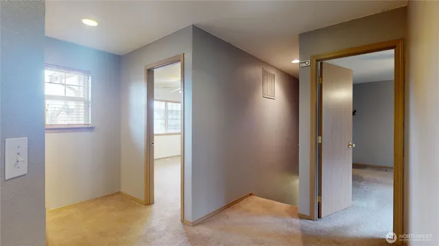 an empty room with windows and closet