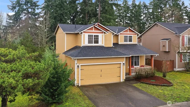 a front view of a house with a yard and garage