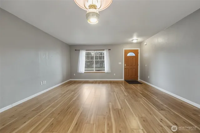 wooden floor in an empty room with a window