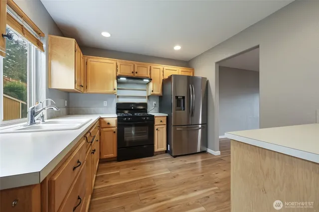 a kitchen with a refrigerator and a sink