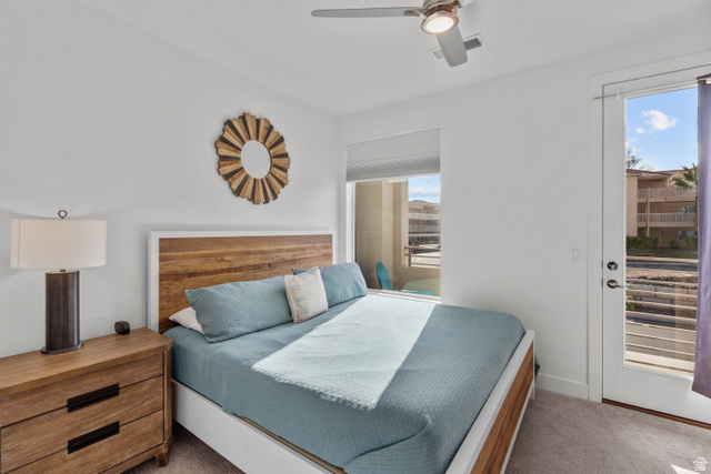 1122 South 1790th West, Unit 1 St. George, UT 84770 - Photo 29 of 37 Bedroom featuring a wood-finish bed frame, white walls, and carpet flooring