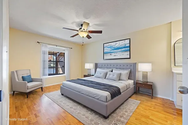 a spacious bedroom with a bed a couch and a bookshelf