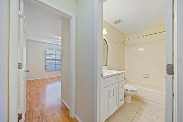 a bathroom with a granite countertop sink a toilet and shower