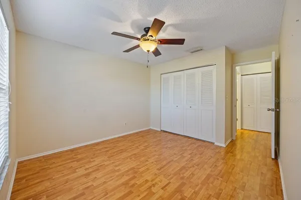 a view of empty room with wooden floor