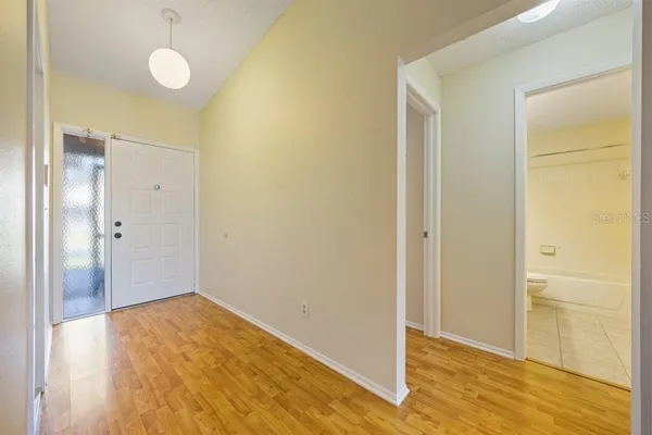 a view of an empty room with wooden floor