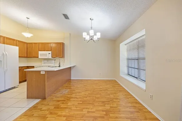 a large kitchen with kitchen island a sink stainless steel appliances and cabinets