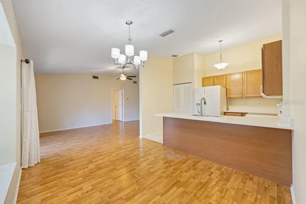 a view of a kitchen with a sink and refrigerator