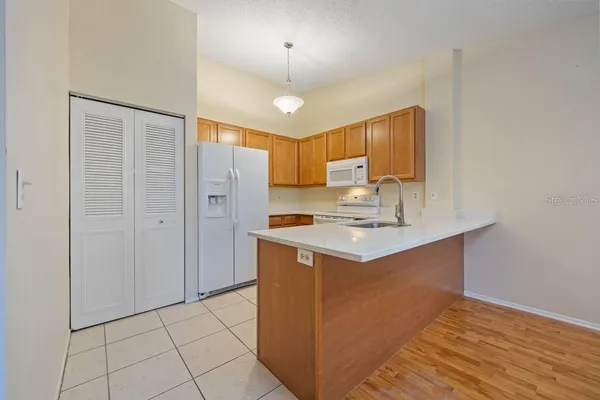 a kitchen with stainless steel appliances a sink stove and refrigerator