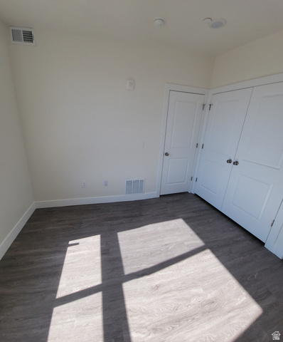 2101 North Main Street, Unit 309 Sunset, UT 84015 - Photo 6 of 17 Unfurnished bedroom with dark wood-style flooring and a closet
