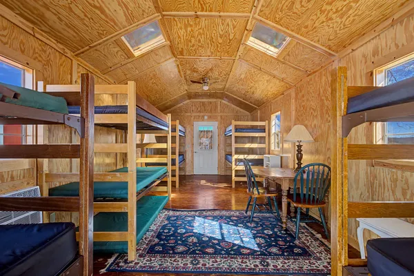 a dining room with a table chairs and a kitchen view