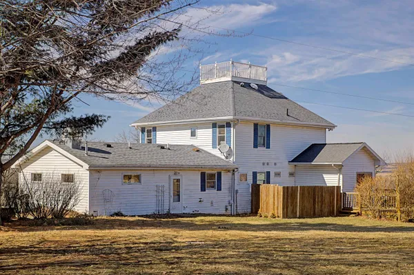 a view of a patio with table and chairs with wooden floor and fence