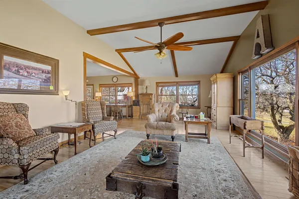 a view of a patio with dining table and chairs with wooden floor
