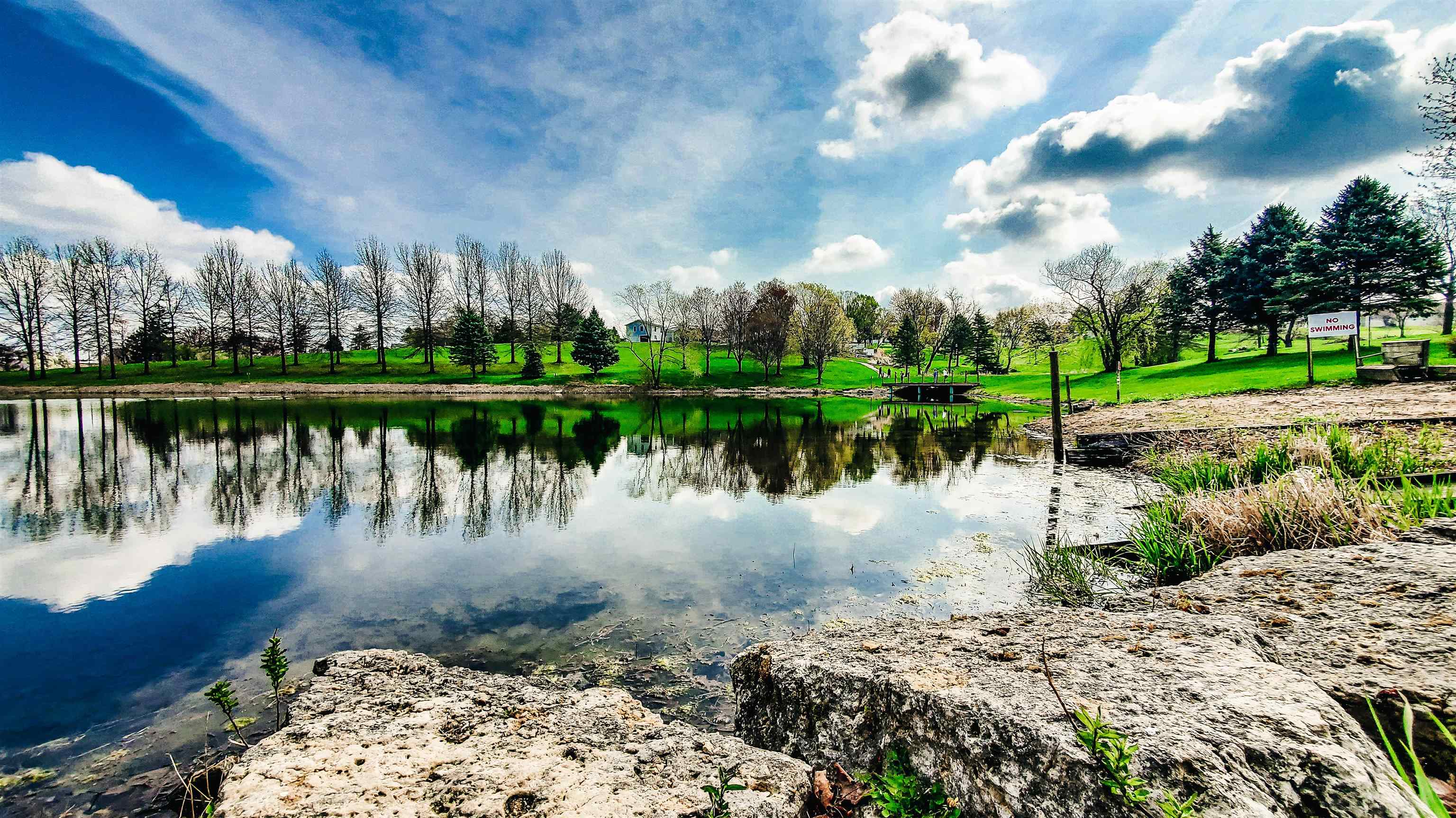 115 Windmill Road Elizabeth, IL 61028 - Photo 65 of 82 a view of a lake with a house in the background