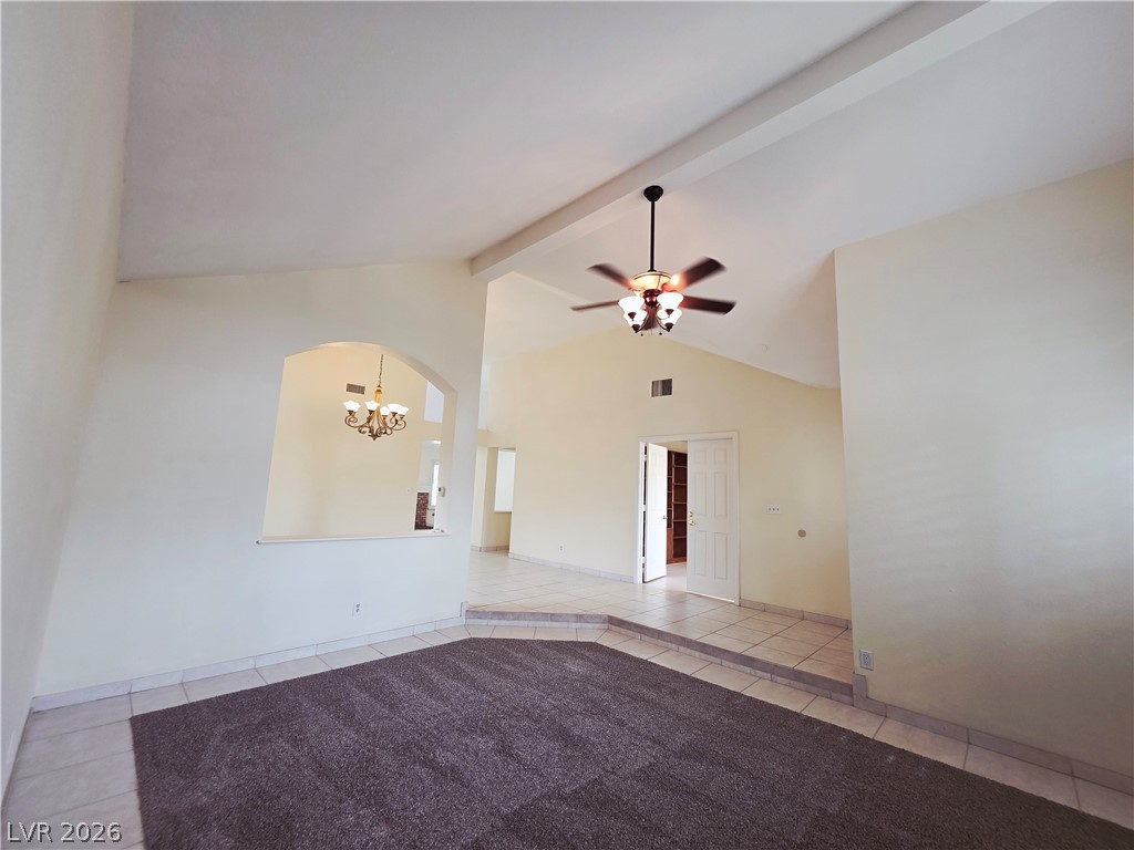 2920 Setting Sun Street Las Vegas, NV 89117 - Photo 10 of 43 This living area features a soaring vaulted ceiling and tile flooring, creating an expansive feel.