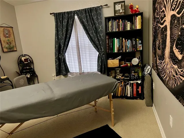 a bedroom with a bed and a book shelf