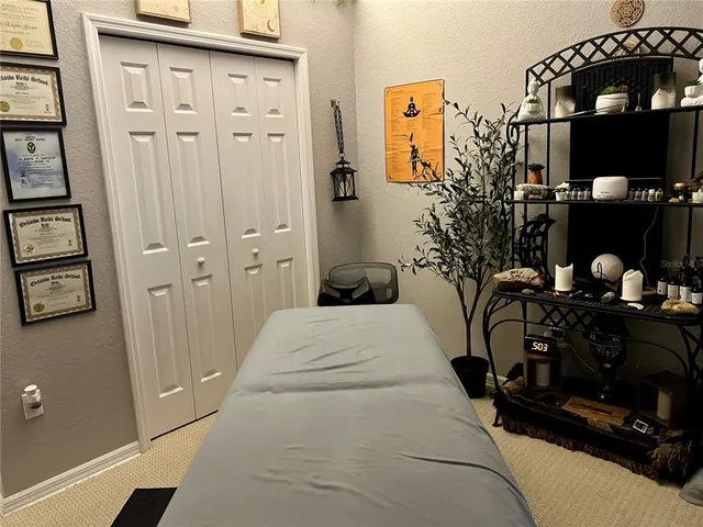 a bedroom with furniture and gym equipment