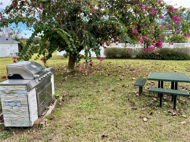 a view of house with backyard and sitting area