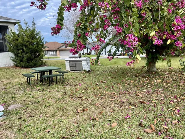 a backyard of a house with table and chairs