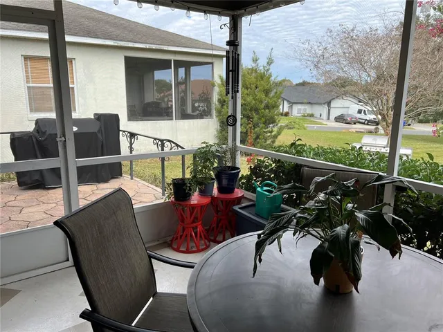 a view of balcony with chairs and potted plants