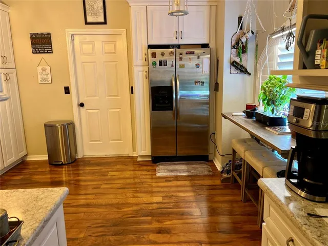 a kitchen with stainless steel appliances granite countertop a refrigerator and a stove
