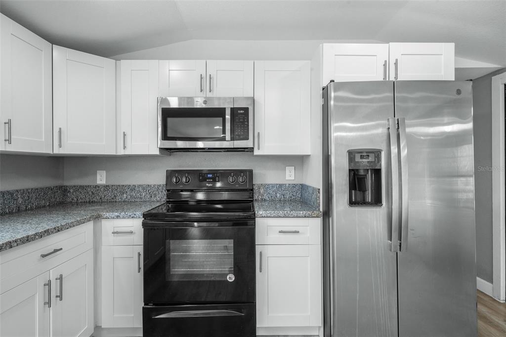 108 Ballard Road Avon Park, FL 33825 - Photo 5 of 12 a kitchen with stainless steel appliances granite countertop a refrigerator and a stove