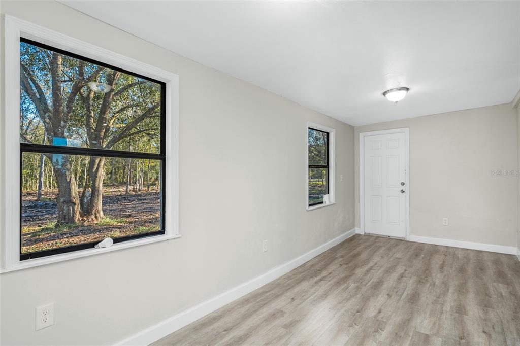 108 Ballard Road Avon Park, FL 33825 - Photo 8 of 12 wooden floor in an empty room with a window