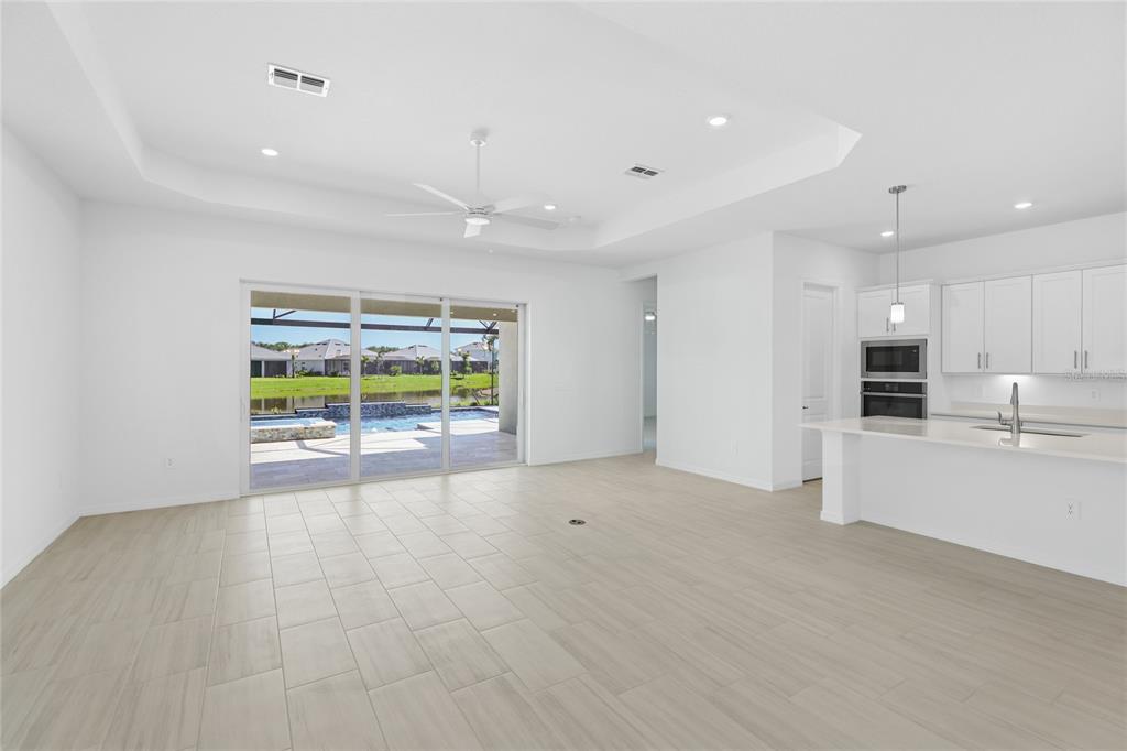 19156 Cherrystone Way Lakewood Ranch, FL 34211 - Photo 5 of 49 a view of an empty room with a window and kitchen view