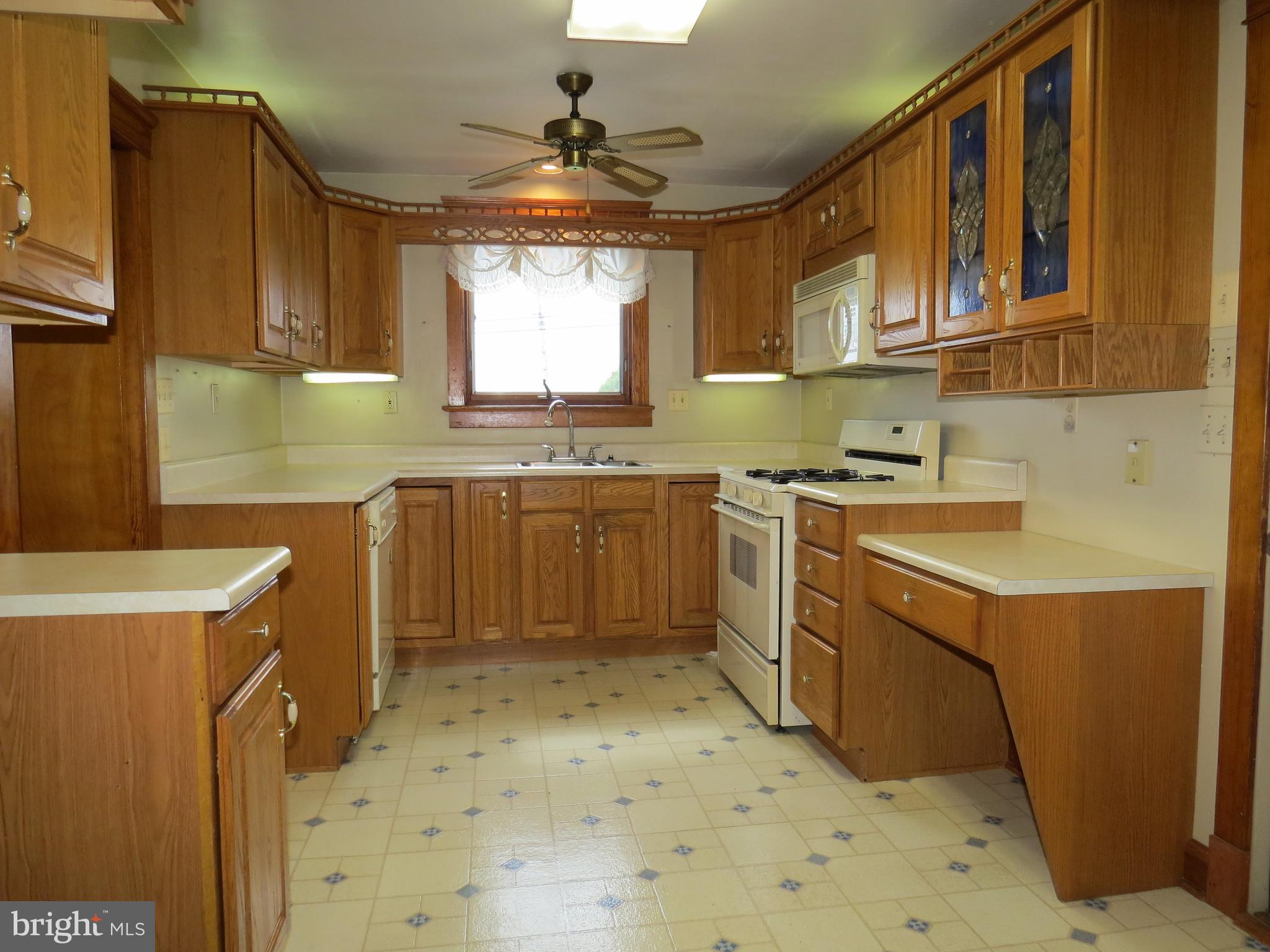4418 Upper Beckleysville Road Hampstead, MD 21074 - Photo 3 of 25 a kitchen with a sink stove and cabinets