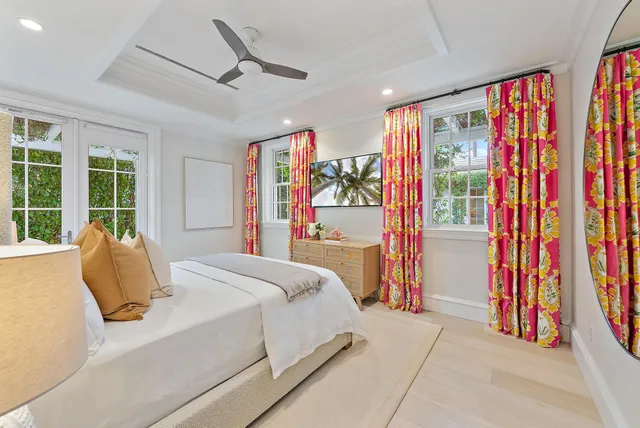 a bedroom with a bed and a large window