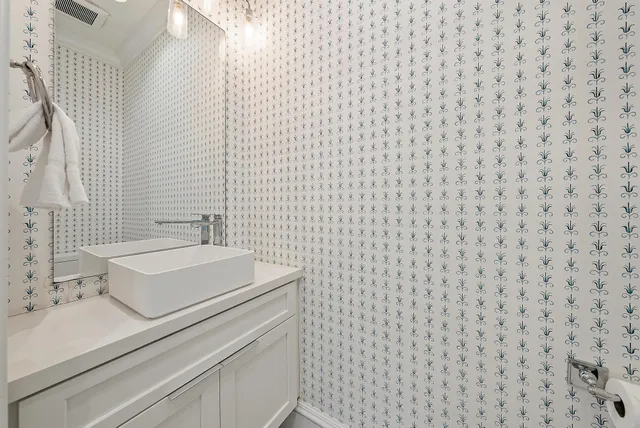 a bathroom with a sink a toilet and mirror