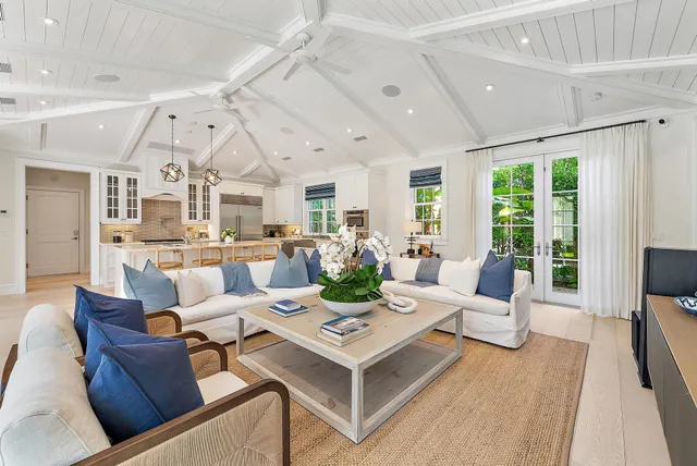 a living room with lots of furniture and a large window