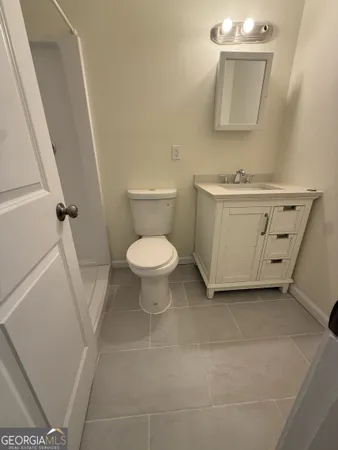 a bathroom with a sink toilet and mirror