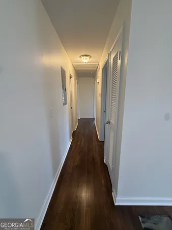 a view of a hallway with wooden floor